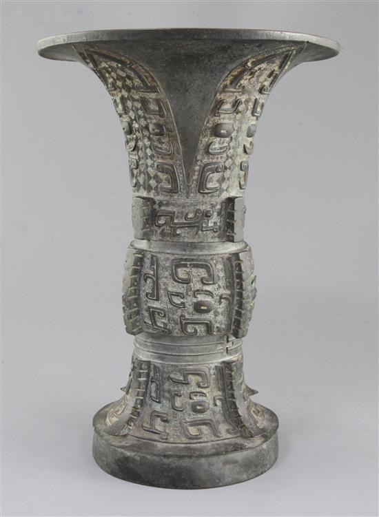 A Chinese archaic bronze ritual wine vessel, Zun, late Shang/early Western Zhou dynasty, 35.5cm high, split to foot